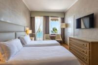 A bed or beds in a room at B&B HOTEL Diano Marina Palace