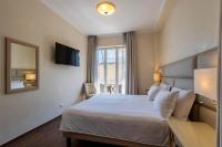 A bed or beds in a room at B&B HOTEL Diano Marina Palace