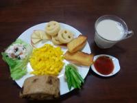 a plate of breakfast food with a glass of milk at Xinyue B&amp;B in Fenglin
