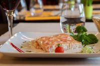a white plate with a piece of food on a table at Brit Hotel Saint-Méen-le-Grand en Brocéliande in Saint-Onen-la-Chapelle