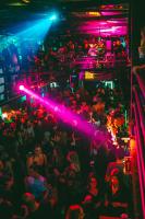 a crowd of people at a nightclub with purple lights at Timeout Heritage Hotel Zagreb in Zagreb