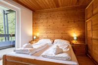 A bed or beds in a room at Appartementanlage Thermenblick SKI IN & SKI OUT