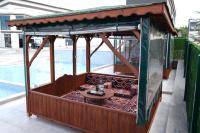 a small gazebo with a table in it next to a pool at Villa Kent Termal Otel in Gazligol