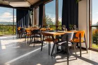 a restaurant with tables and chairs and large windows at Summit in Yablunytsya