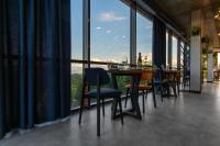 a dining room with a table and chairs and large windows at Summit in Yablunytsya