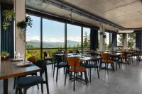 a restaurant with tables and chairs and large windows at Summit in Yablunytsya