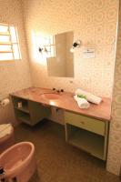 a bathroom with a sink and a mirror at Pousada Sino dos Ventos in Campos do Jordão