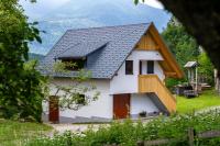 a white house with a black roof at Apartment Orehar in Bohinj