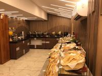 a kitchen with a long counter with food on it at El Mesaadya Hotel فندق المساعدية in Cairo