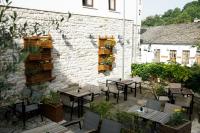a patio with tables and chairs in front of a building at Hotel Kalemi 2 in Gjirokastër