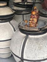 a piece of meat on a plate on top of a pot at Senger Qala in Qax