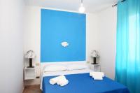 A bed or beds in a room at Favignana Margot House