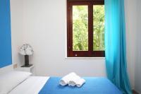A bed or beds in a room at Favignana Margot House