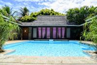 a swimming pool in front of a house at Pool Mountain Moorea in Moorea