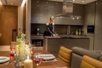 a woman standing in a kitchen preparing food at Four Seasons Hotel in Limassol