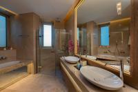 a large bathroom with two sinks and a shower at Four Seasons Hotel in Limassol