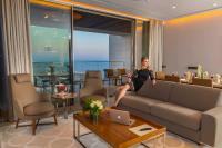 a woman sitting on a couch in a living room at Four Seasons Hotel in Limassol