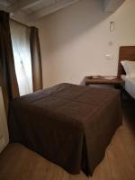 A bed or beds in a room at Carrera Home Appartamenti Verona - Bike Hotel