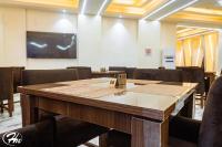 a conference room with a wooden table and chairs at Hadmof Hotel and Suites in Ikeja