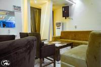 a waiting room with a couch and a table at Hadmof Hotel and Suites in Ikeja