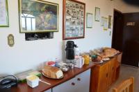 a kitchen counter with bread and other items on it at Pousada Colina Da Neve in São Joaquim