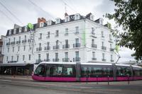 a pink tram in front of a white building at Campanile Dijon Centre - Gare in Dijon