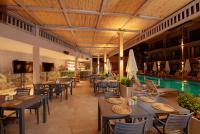 a restaurant with tables and chairs and a swimming pool at Casa Lumar Luxury Lodging- Adult Only in Fethiye