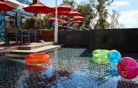 a swimming pool with colorful balls in the water at Amari Phuket in Patong Beach