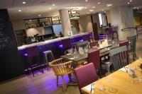 a restaurant with tables and chairs and a bar at Campanile Dijon Centre - Gare in Dijon