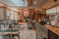 a restaurant with tables and chairs and a brick wall at Aparthotel Góralski Spa & Restaurant in Białka Tatrzanska