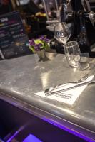 a table with two wine glasses and a napkin at Campanile Dijon Centre - Gare in Dijon