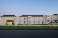 a large white building with a street in front of it at Ramada by Wyndham Cheltenham in Cheltenham