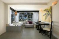 a living room with a tub and a table and a dining room at Hidden Beach Resort Au Naturel Adults Only Catamarán, Cenote & More Inclusive in Akumal