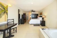 a bedroom with a bed and a bath tub at Hidden Beach Resort Au Naturel Adults Only Catamarán, Cenote & More Inclusive in Akumal