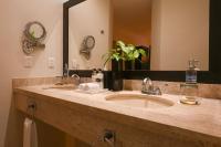 a bathroom with two sinks and a large mirror at Hidden Beach Resort Au Naturel Adults Only Catamarán, Cenote & More Inclusive in Akumal