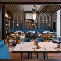 マカオにあるAndaz Macau, By Hyattのテーブルと椅子のあるレストラン、ダイニングルーム