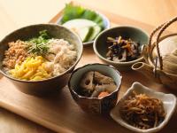 a group of bowls of food on a wooden table at HOTEL SUI AKASAKA by ABEST in Tokyo