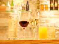 three glasses of wine and some drinks on a table at HOTEL SUI AKASAKA by ABEST in Tokyo
