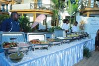 a buffet of food is set up on a table at Mowicribs Hotel and Spa in Entebbe