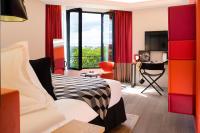 a hotel room with a bed and a desk and a window at Terrass&quot; Hotel in Paris