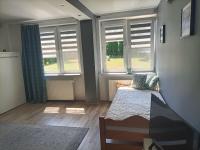 Posteľ alebo postele v izbe v ubytovaní Apartament Blekit Nieba