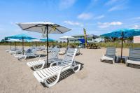 a row of lounge chairs and umbrellas on a beach at Ocean View Hotel Room with Balcony- King Bed #19 in Fort Pierce