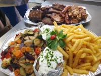 two plates of food with french fries and meat at Gasthof International in Hieflau