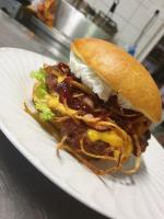 a sandwich on a white plate on a table at Gasthof International in Hieflau