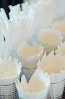 a pile of white cupcakes in white bowls at โรงแรมกัญธิญา การ์เด้น Kanthiya garden hotel in Ban Si Muang Mai