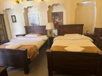 Ein Bett oder Betten in einem Zimmer der Unterkunft Heritage Home Guest House