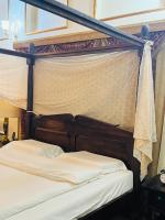 Ein Bett oder Betten in einem Zimmer der Unterkunft Heritage Home Guest House