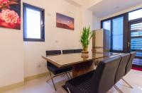 a dining room with a table and chairs at Happy House Homestay in Hualien City