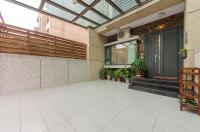 an empty patio with a glass ceiling and a door at Happy House Homestay in Hualien City