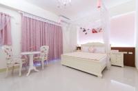 a bedroom with a bed and a table and chairs at Happy House Homestay in Hualien City